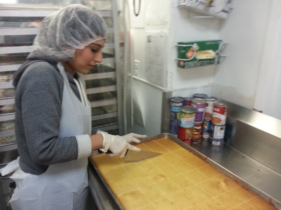 Sundas at the DC Central Kitchen cutting and packing corn cake to help prepare meals for the homeless