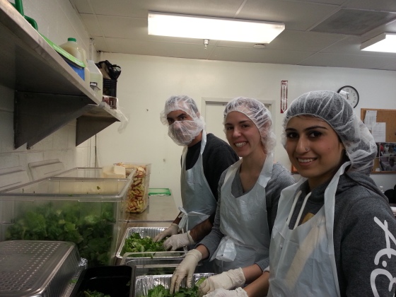 Sundas Liaqat with other volunteers at DC Central Kitchen cleaning salad leaves to help prepare meal for the homeless